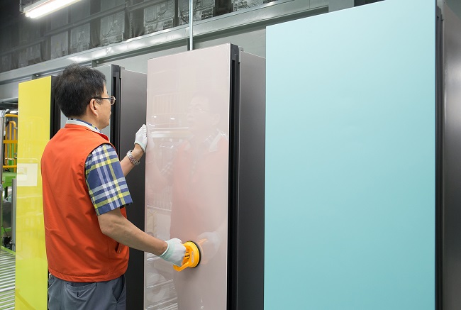 This photo provided by Samsung Electronics Co. on Jan. 6, 2021, shows a worker inspecting the company's Bespoke refrigerator at a manufacturing plant in Gwangju, South Korea.