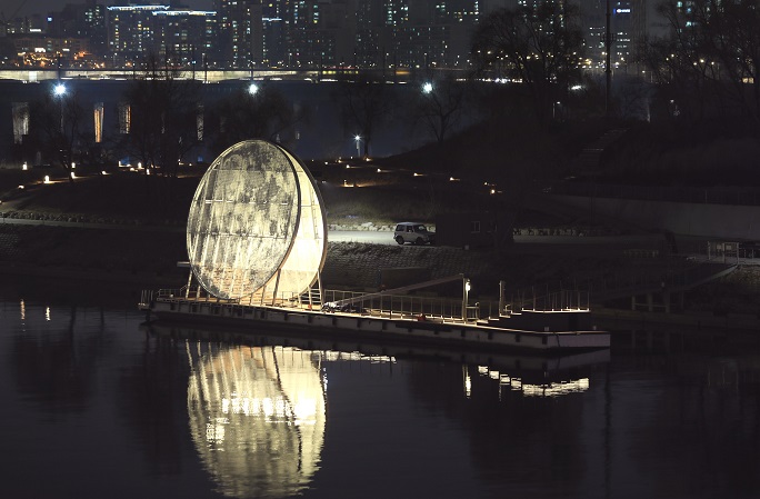 This photo, provided by the Seoul city government on Jan. 4, 2020, shows a night view of the giant moon-shaped art installation by Nodeul Island in Seoul.