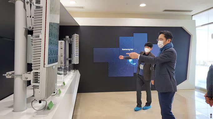 This photo provided by Samsung Electronics Co. shows Samsung Electronics Vice Chairman Lee Jae-yong (R) checking a network equipment manufacturing facility at the company's plant in Suwon on Jan. 5, 2021.