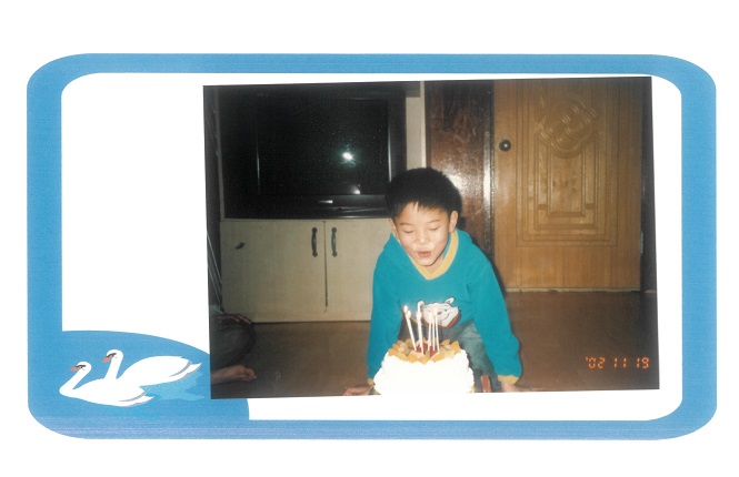 A young Shin Seon blows out candles on his birthday cake, in this undated photo provided by Shin and The Beautiful Foundation.