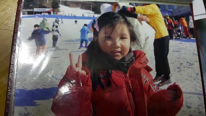 A young Kang Young-a makes a peace sign at the camera, in this undated photo provided by Kang and The Beautiful Foundation. 