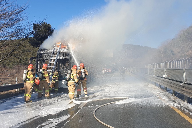 Firefighters put out a fire on a Hyundai Motor Co. electric bus in Changwon, about 400 kilometers southeast of Soul, on Feb. 15, 2021, in this photo provided by Changwon Fire Station.