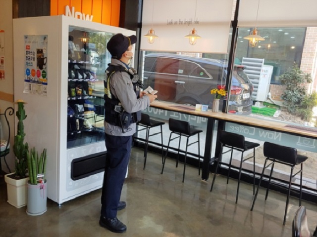 This photo provide by Wanju Police Station shows a policeman inspecting an unmanned store.