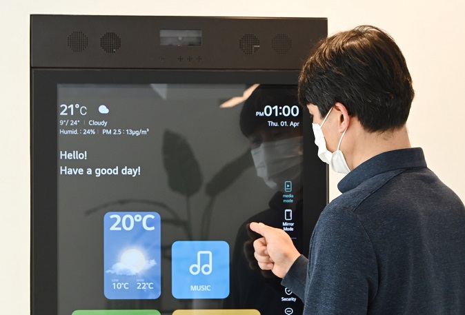This photo provided by LG Electronics Inc. on April 6, 2021, shows a researcher from the company checking a smart mirror to use artificial intelligence (AI)-powered services from KT Corp. at LG's smart home in Seongnam, south of Seoul.