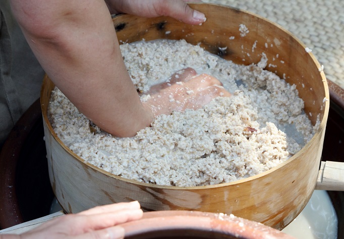 This photo, provided by the National Folk Museum of Korea, shows the process of making "makgeolli," a South Korean traditional grain-based alcoholic drink.