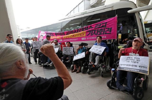 A group of activists stages a protest at Seoul Express Bus Terminal in southern Seoul on Sept. 12, 2019, demanding the government allocate more of its budget toward installing facilities for wheelchairs. (Yonhap)