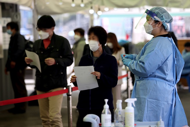This April 15, 2021, photo shows citizens waiting to be tested for COVID-19 in Seoul. (Yonhap)