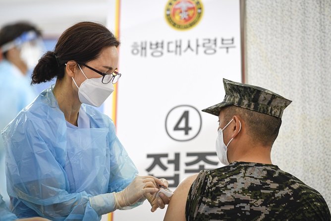 A Marine receives a COVID-19 shot at the Marine Corps headquarters in Hwaseong, 60 kilometers south of Seoul, in this photo provided by the service.