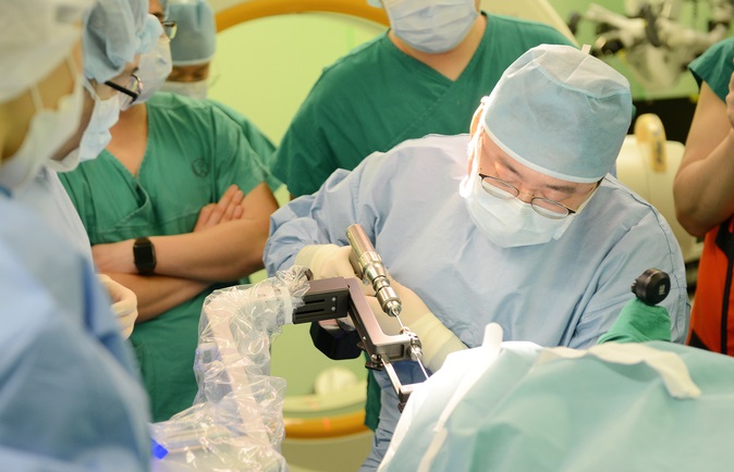 This photo provided by Severance Hospital shows its medical team performing surgery using a surgical robot.