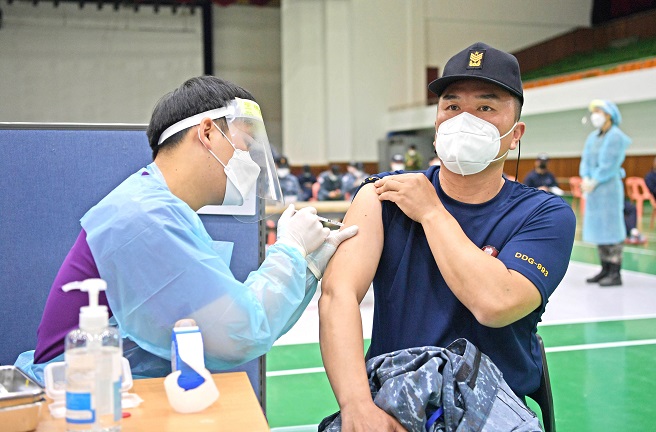 A Navy officer receives the first jab of AstraZeneca's COVID-19 vaccine at a vaccination center at a Naval base in Jinhae on the southeastern coast on April 28, 2021, in this photo provided by the South Korean defense ministry. 