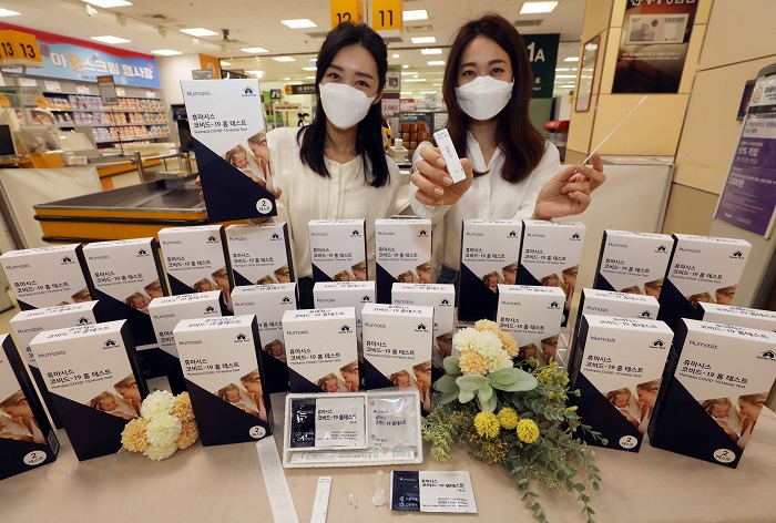 Models present Humasis' COVID-19 self-testing kit at an E-Mart outlet in southeastern Seoul on May 6, 2021, in this photo provided by the discount store chain.