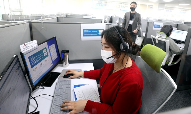 A worker takes a call at a call center in Seoul. (Yonhap)