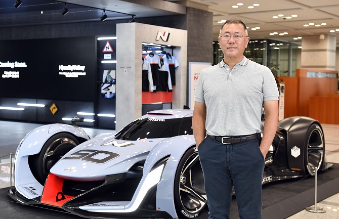This undated photo provided by Hyundai Motor Group shows Chairman Chung Euisun standing in front of a high-end N performance car at the group's headquarters building in Yangjae, southern Seoul.