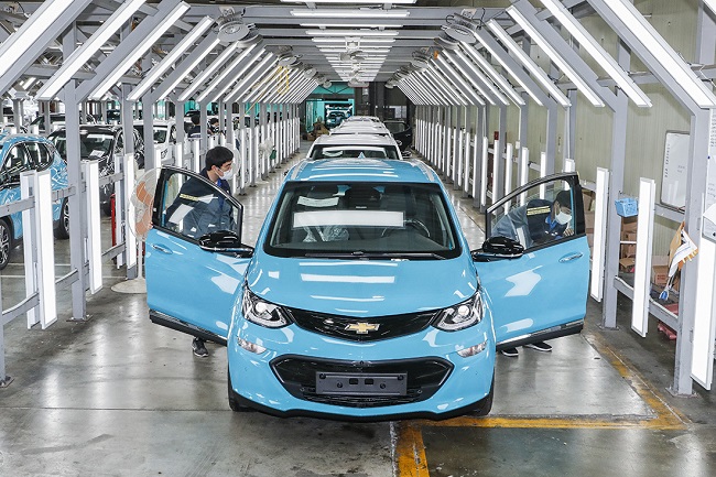 Employees of GM Korea check Bolt EVs at a factory before their delivery to Lotte Foods Co., which signed a purchase deal of 380 units, in this photo provided by the South Korean unit of General Motors Co. on May 23, 2021.
