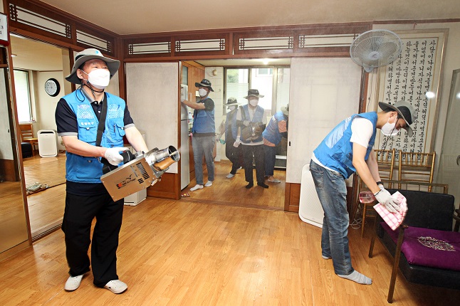 Public health workers disinfect a community center for the elderly in southern Seoul on June 18, 2021, ahead of its reopening on June 21, in this photo provided by the city's Dongjak Ward.