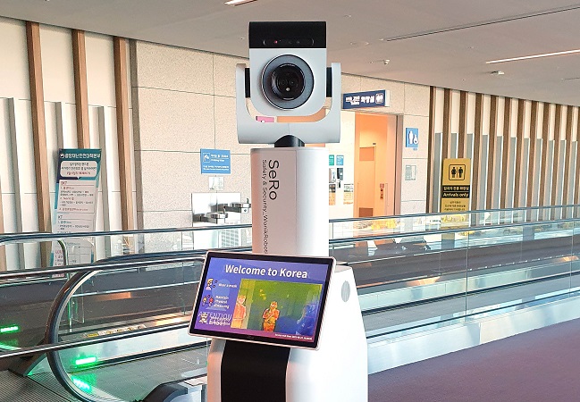 This photo, provided by Incheon International Airport Corp., shows a robot that guides entrants through procedures for COVID-19 tests, introduced at the airport, west of Seoul, on July 5, 2021.
