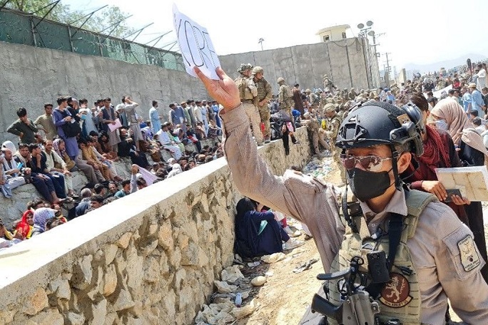 A soldier from troops belonging to one of South Korea's partner countries looks for Afghans who were to be airlifted from Kabul in this photo provided by the foreign ministry on Aug. 25, 2021.