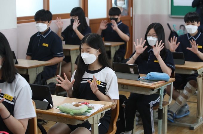 Students attend a summer vacation ceremony via tablet PCs at Seongdang Middle School in Daegu, 300 kilometers southeast of Seoul, on July 14, 2021, as part of preparations for possible online classes in the fall semester amid the resurgence of COVID-19. (Yonhap)