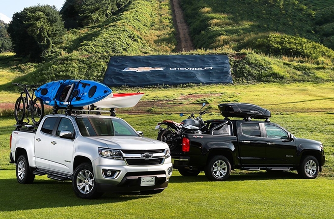 This photo provided by GM Korea on Aug. 26, 2019, shows Colorado pickup trucks, carrying a bicycle, a motorcycle and kayaks, at Welli Hilli Park in Hoengseong, 140 kilometers east of Seoul.