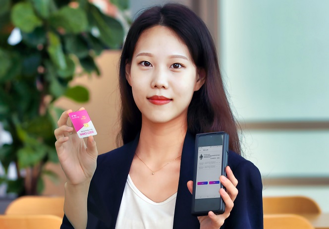 In this photo provided by LG Uplus Corp., a model shows the company's PUF-based USIM card.