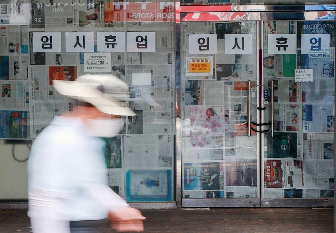 This file photo, taken Sept. 6, 2021, shows a sign announcing a temporary closure over COVID-19 at a convenience store in Seoul's nightlife district of Itaewon. (Yonhap)