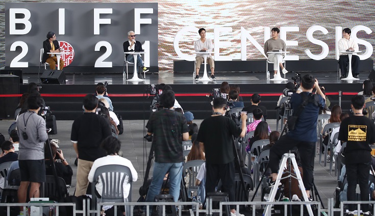 The director and the cast of the opening film "Heaven: To the Land of Happiness" attend a speical program held at the outdoor theater of the Busan Cinema Center during the 26th Busan International Film Festival on Oct. 8, 2021. (Yonhap)