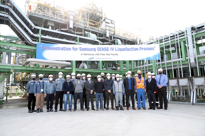 Officials from global key LNG producers, including Italy's ENI, Norway's Equinor and Britain's Golar LNG, and ship quality assurance and risk management companies, such as the U.S.' ABS, pose for a photo after the demonstration of gas liquefaction technology by Samsung Heavy Industries Co. at its shipyard in Geoje Island, about 400 kilometers south of Seoul, in this photo provided by the shipbuilder on Nov. 18, 2021.