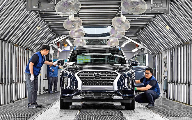 This undated file photo provided by Hyundai Motor shows cars rolling off the assembly line at a factory.
