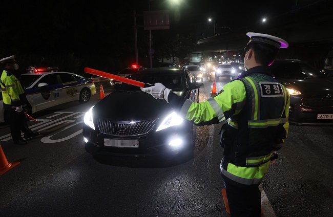 Police officers check vehicles for drunk driving at a DUI checkpoint in Seoul on Nov. 6, 2021. (Yonhap)