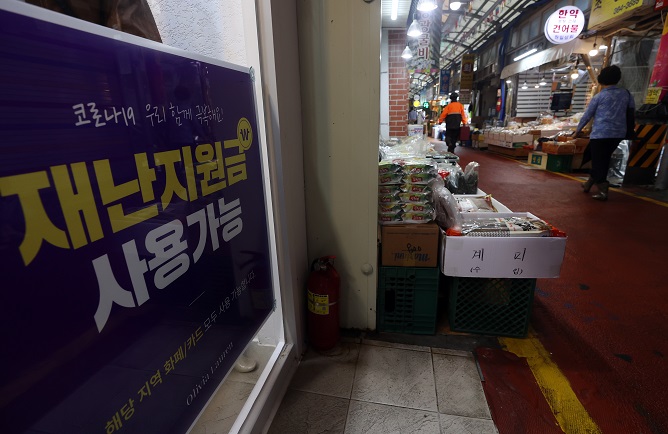 This file photo, taken Sept. 7, 2021, shows a sign at a traditional market in Seoul that says people can use emergency relief funds at the market. (Yonhap)