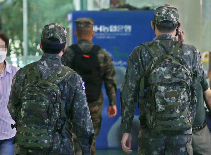 In this file photo taken Oct. 3, 2021, soldiers walk at a bus terminal in eastern Seoul. (Yonhap)