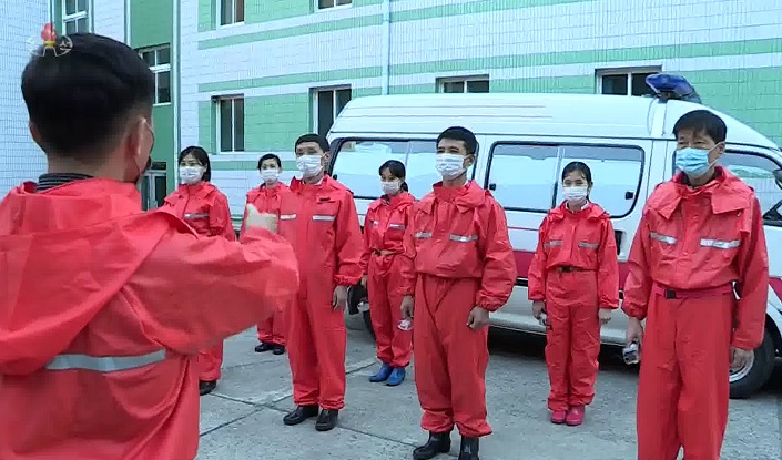 This undated image, captured from North Korea's state TV on Dec. 1, 2021, shows its quarantine workers. (Yonhap)
