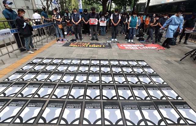 This June 19, 2021, file photo shows a silent tribute to workers who have died in industrial accidents in front of Seoul Regional Employment and Labor Administration in central Seoul. (Yonhap)