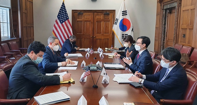 South Korean Trade Minister Yeo Han-koo (2nd from R) speaks with U.S. Deputy Secretary of Commerce Don Graves (2nd from L) during their meeting in Washington on March 3, 2022, in this photo provided by the South Korean ministry. 