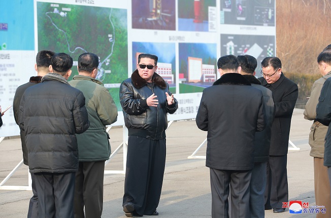 North Korean leader Kim Jong-un (C) talks with officials during a visit to the Sohae Satellite Launching Ground in Cholsan, North Pyongan Province, in this undated photo released on March 11, 2022, by the North's official Korean Central News Agency. Kim's visit to the satellite test site on the west coast came as Seoul and Washington jointly concluded Pyongyang's recent purported "reconnaissance satellite" development tests were those of a new intercontinental ballistic missile system. (Yonhap)