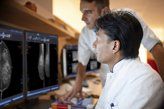 Two doctors reviewing mammogram case 