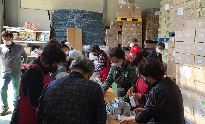 Workers from Global Life Sharing, a Seoul-based nonprofit group, package medicine and other medical supplies to be donated to Ukraine in Ansan, Gyeonggi Province, on April 11, 2022, in this photo provided by the group.