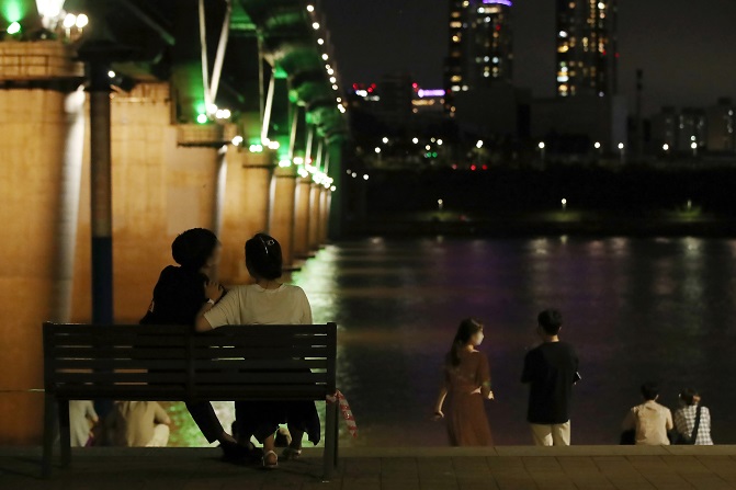 This photo shows people at leisure alongside the Han River. (Yonhap)