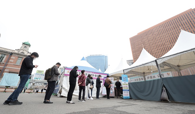 People line up to get tested for COVID-19 at a makeshift clinic on April 12, 2022. (Yonhap)