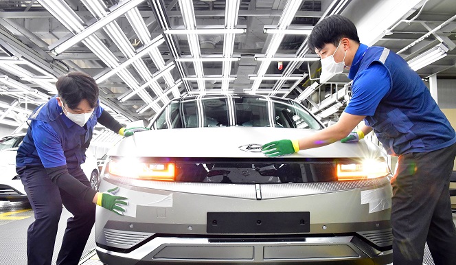 This undated file photo provided by Hyundai Motor shows workers assembling the all-electric IONIQ 5 at the carmaker's main plant in Ulsan, 414 kilometers southeast of Seoul.
