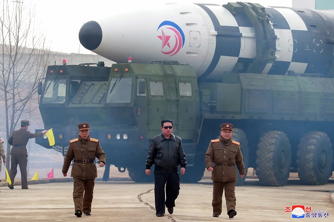 North Korean leader Kim Jong-un (C) visits Pyongyang International Airport on March 24, 2022, to inspect the launch of an intercontinental ballistic missile (ICBM), in this photo released by the North's official Korean Central News Agency.  (Yonhap)