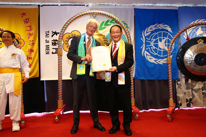 Dr. Hong, Tao-Tze, president of FOWPAL, presents a Certificate to Dr. Aldo Manos, former director of United Nations Environment Programme, for ringing the Bell of World Peace and Love on June 3, 2022 during Stockholm+50.