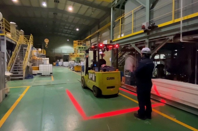 This photo provided by POSCO shows the company's employee demonstrating forklift safety lights.