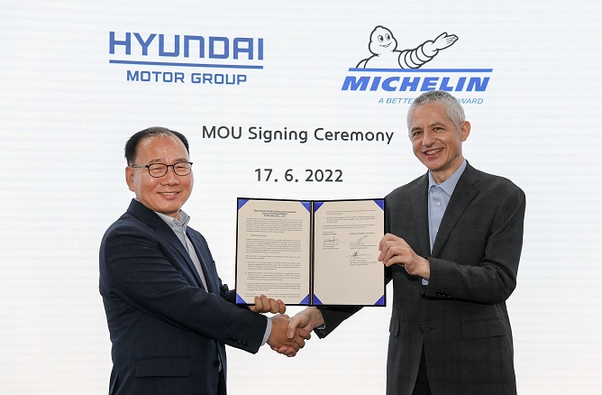 Kim Bong-soo (L), a Hyundai Motor Co. executive, and Georges Levy, a Michelin vice president, pose for a photo after signing a memorandum of understanding on the development of electric car-only and environment-friendly tires at a Hyundai research center in Hwaseong, about 40 kilometers south of Seoul, on June 17, 2022, in this photo provided by the South Korean carmaker.