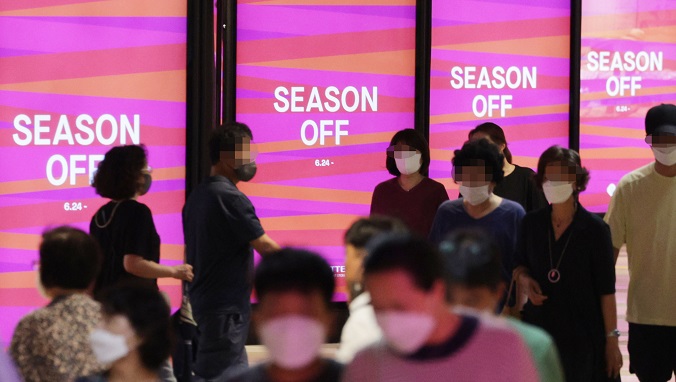 People walk past a department store in Seoul on June 24, 2022. (Yonhap)