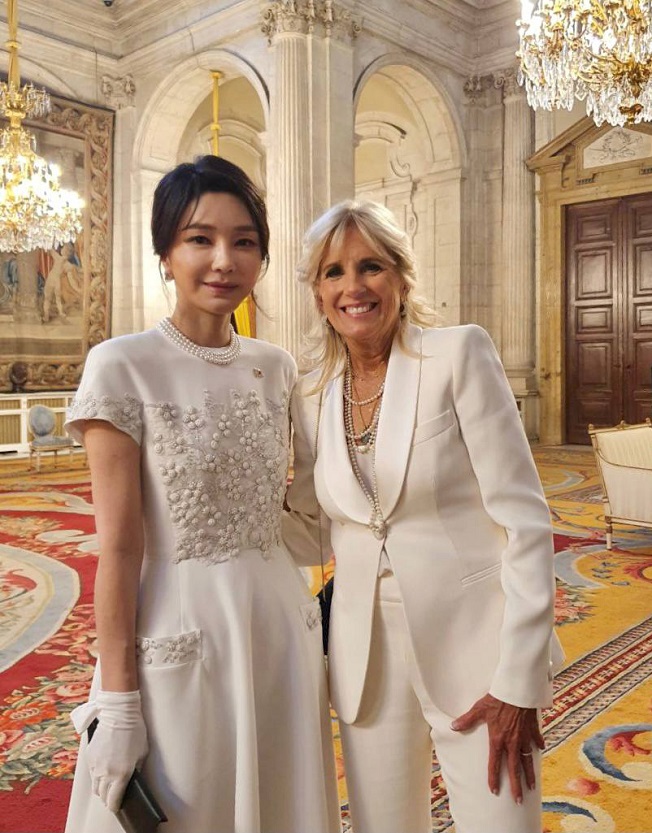 This photo, provided by the presidential office, shows first lady Kim Keon-hee (L) and U.S. first lady Jill Biden posing for a photo at a gala dinner held at the Royal Palace of Madrid on June 28, 2022.