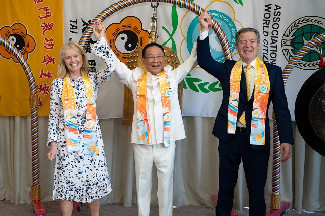 From left, Dr. Katrina Lantos Swett, president of the Lantos Foundation for Human Rights and Justice; Dr. Hong, Tao-Tze, zhang-men-ren (grandmaster) of Tai Ji Men and president of the Federation of World Peace and Love (FOWPAL); and former U.S. Ambassador-at-Large for International Religious Freedom Sam Brownback, right, hold hands to show solidarity for the promotion of love and peace in the world after Dr. Swett’s and Amb. Brownback’s ringing the Bell of World Peace and Love in Washington, D.C. on June 28, 2022. 