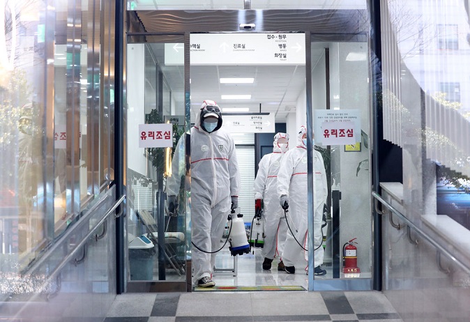 Health authorities disinfect a hospital in Busan on Feb. 24, 2020. (Yonhap)