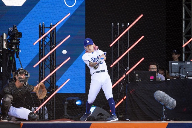 South Korean short track speed skater Kwak Yoon-gy (R) takes a swing during FTX MLB Home Run Derby X at Crystal Palace Park in London on July 9, 2022, in this file photo provided by Major League Baseball.