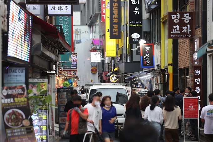 The central shopping district of Myeongdong in Seoul is busy with people on June 29, 2022. (Yonhap)